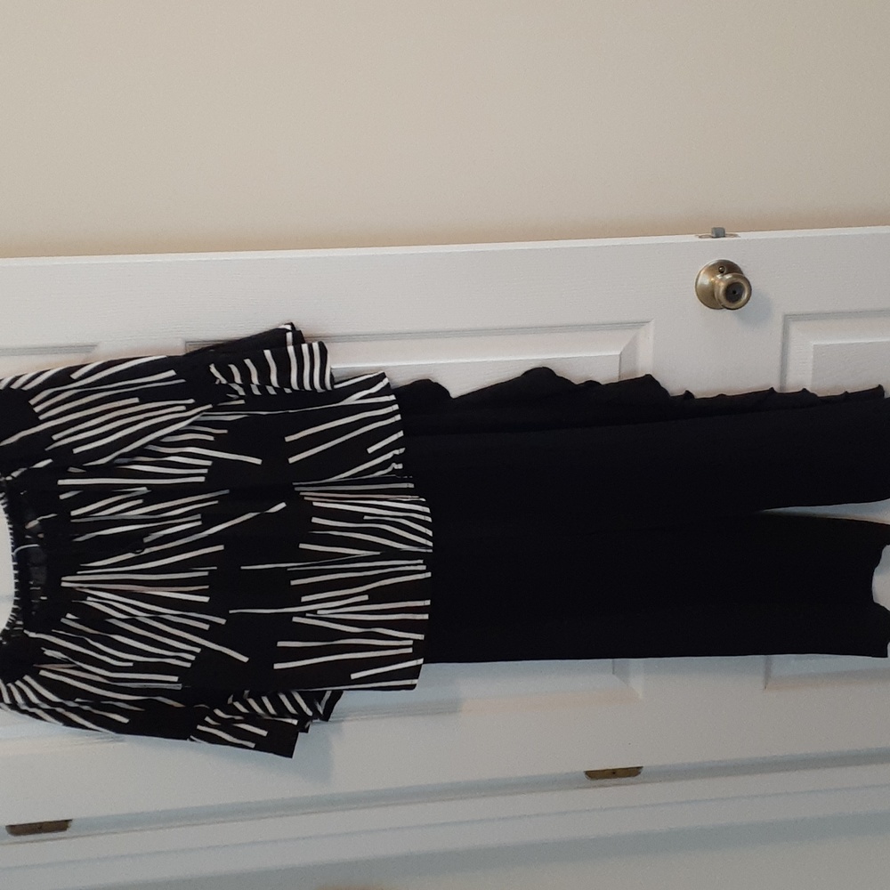 Black and white top/ with flowy black pants that have ruffles down the sides